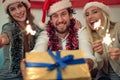 People with sparklers and gift enjoying in party on Christmas day Royalty Free Stock Photo