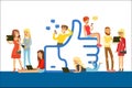 Young people standing and sitting near giant Like symbol, man and woman using mobile gadgets for social networking or