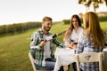 Young people by the table in the vineyard Royalty Free Stock Photo