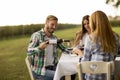 Young people by the table in the vineyard Royalty Free Stock Photo