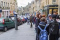 Young people talking to each other on a business street in Edinburgh, Scotland