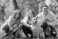 Young people with their dogs in the park at a Dog Show looking at the camera