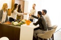 Young people toasting white wine in modern kitchen Royalty Free Stock Photo