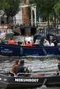 Young people on a tourist trip on a boat in the city canals Royalty Free Stock Photo