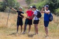 Young people with the trekking poles doing the Way of Saint James in Spain reading the map to orientate themselves looking with