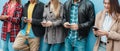 Young people using mobile phones outdoor in the city - Focus on right man face Royalty Free Stock Photo