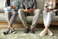 Young people using mobile phones on sofa. Concept of addiction Royalty Free Stock Photo