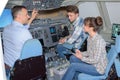 Young people visiting aircraft simulator Royalty Free Stock Photo