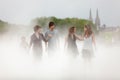 Young people walking in the fog
