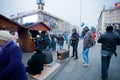 Young people warm themselves by the vintage stove on the street during the week of pro-European protest