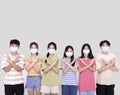 Young people wearing face masks during covid-19 pandemic .Group of teenagers with deny gestures
