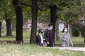 Young people wearing face masks while walking in nature, in city public park