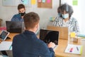 Young people working inside modern office behind plexiglas - Focus woman face