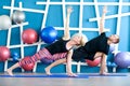 Young people in yoga class in Extended Side Angle Pose. Yoga group concept