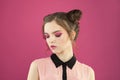 Young perfect fashion model woman with pink eyeshadow makeup on colorful pink background