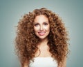 Young perfect redhead woman with long healthy curly hair and cute smile. Beautiful female face