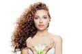 Young perfect woman with long curly hairstyle, healthy skin and lily flower in her hands isolated on white background Royalty Free Stock Photo