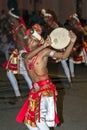 A young performer dances along a street in Kandy during the Esala Perahera great procession.