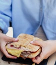 young person enjoying a beef sandwich