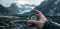 a young person hand holding a compass full of mountains Royalty Free Stock Photo