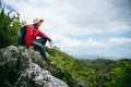 Young person hiking male on top rock, Backpack man looking at beautiful mountain valley at sunlight in summer, Landscape with Royalty Free Stock Photo