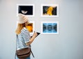 Young person at photo frame write digital book leaning against at show exhibit artwork gallery Royalty Free Stock Photo