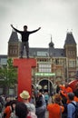 Young person standing on top of the Iamsterdam sign.