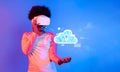 Young person using virtual reality headset with cloud computing graphic on colorful background highlighting online Royalty Free Stock Photo