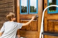 Young person works on repairing wooden door