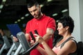 Brunette woman working out with personal coach