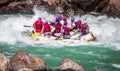 Young persons rafting on the Ganges river in Rishikesh, extreme and fun sport at tourist attraction Royalty Free Stock Photo