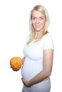 Young Petty Natual Beauty Pregnant Woman Holding Grapefruit and Shows a Belly That Begins to Grow Isolated on White Background.