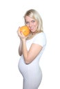 Young Petty Natual Beauty Pregnant Woman Holding Grapefruit and Shows a Belly That Begins to Grow Isolated on White Background.