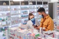 Young pharmacist helping customer to choos medication.