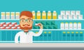 Young pharmacy chemist man standing in drugstore.