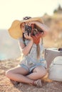 Young photographer with a big hat on a rock Royalty Free Stock Photo