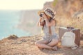 Young photographer with a big hat on a rock Royalty Free Stock Photo