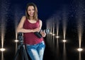 young photographer with camera on hands and rest on the tripod in lights corridor Royalty Free Stock Photo