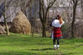 Young photographer dressed in traditional clothes in Maramures county.