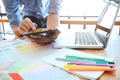 Young photographer and graphic designer at work in studio office Royalty Free Stock Photo