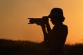 Young Photographing Through Digital Camera Silhouette Against Sunset