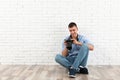 Young photographer  professional camera near brick wall. Space for text Royalty Free Stock Photo