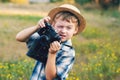 Young photographer in a straw hat with old camera Royalty Free Stock Photo