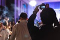 Young photographer taking photo indoor night celebration events, selective focus Royalty Free Stock Photo