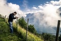 Young photographer is taking a picture in Norway Royalty Free Stock Photo