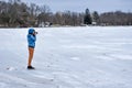 Young Photographer Taking Pictures on Snowy Lake