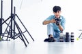 Young photographer is taking pictures in the studio with a digital camera Royalty Free Stock Photo