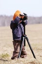 Young photographer with tripod Royalty Free Stock Photo