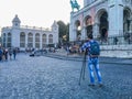 Young photographer with tripod in front of Sacre Coeur basilica on Montmartre in Paris, France