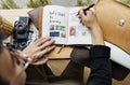 Young photographer writing diary and photo-book Royalty Free Stock Photo